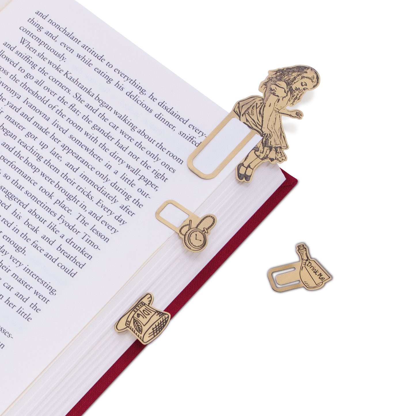 Brass metal bookmarks on an open book.