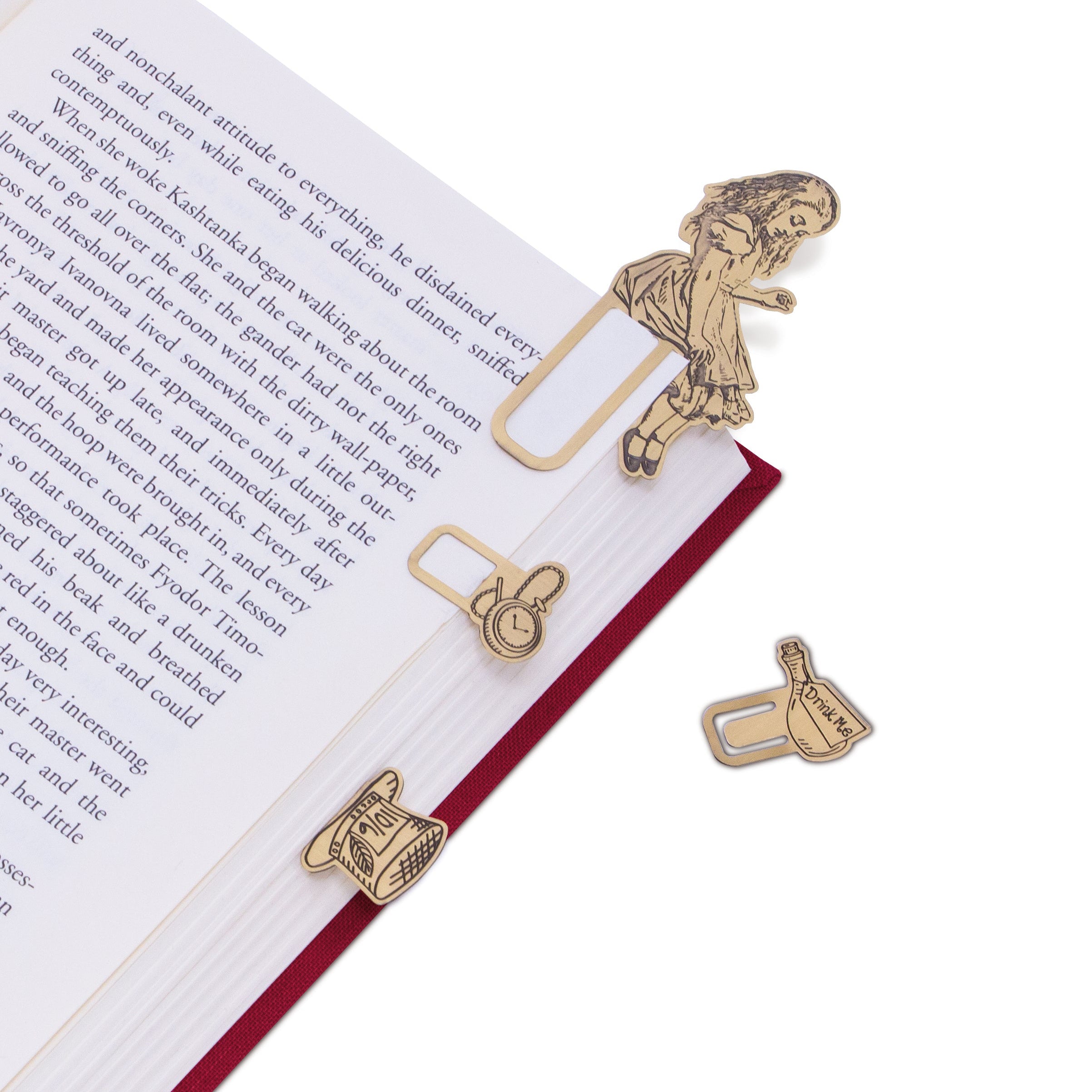 Brass metal bookmarks on an open book.