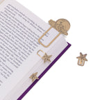 Star-shaped gold bookmarks on an open book with a white background