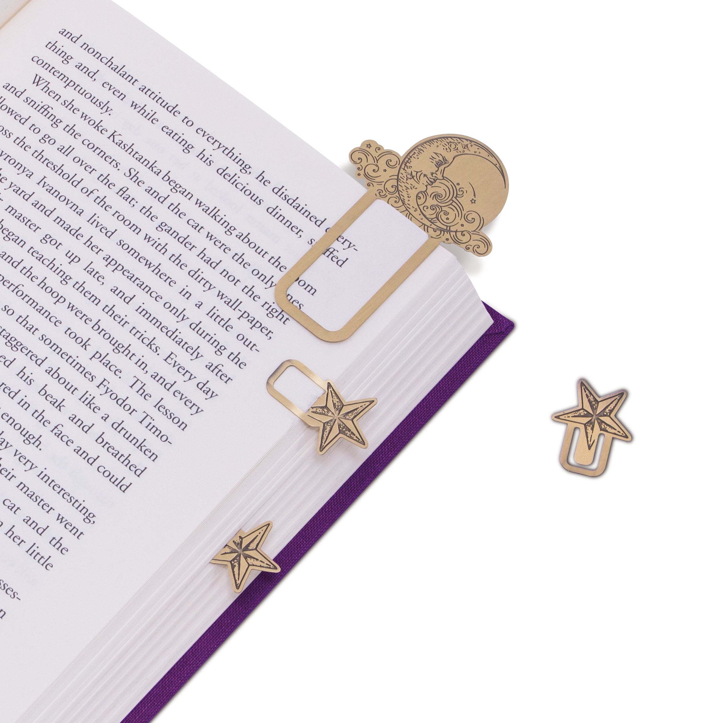 Star-shaped gold bookmarks on an open book with a white background