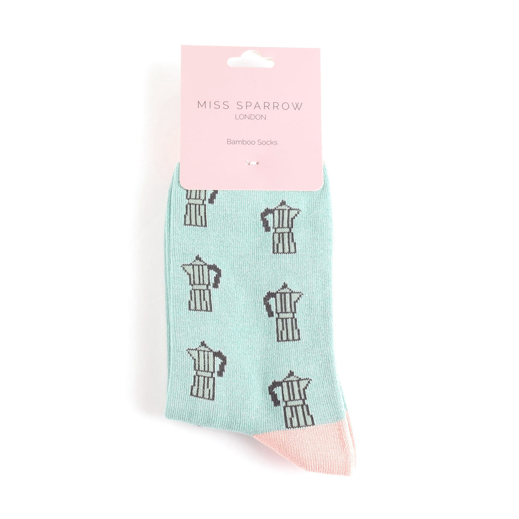 Mint green socks with coffee pot pattern on a white background