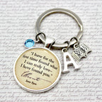 Keychain with a circular charm featuring a jane eyre quote 