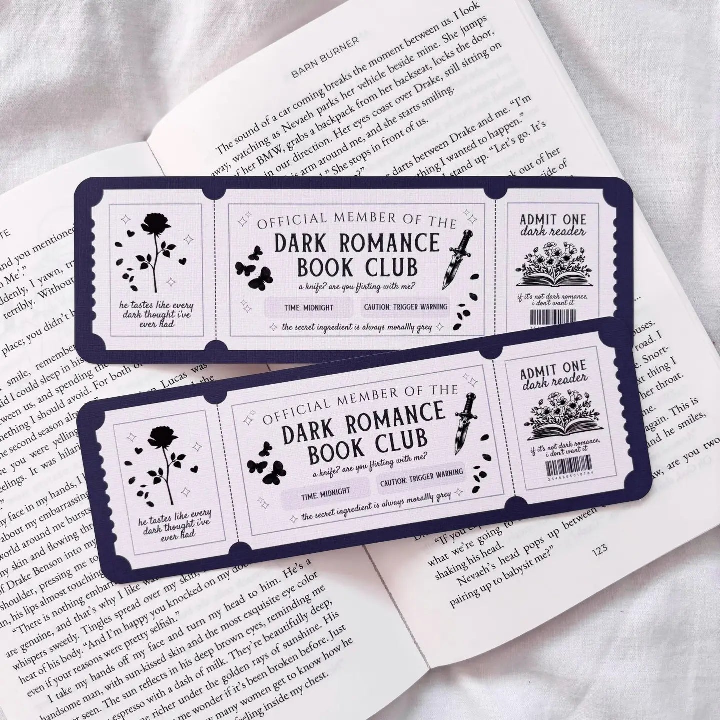 Dark Romance Book Club membership cards on an open book
