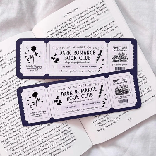 Dark Romance Book Club membership cards on an open book