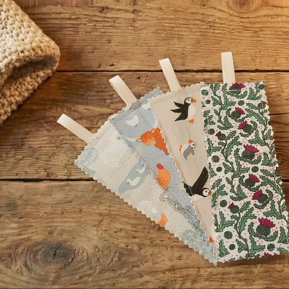 Set of fabric swatches with animal and nature patterns on a wooden surface