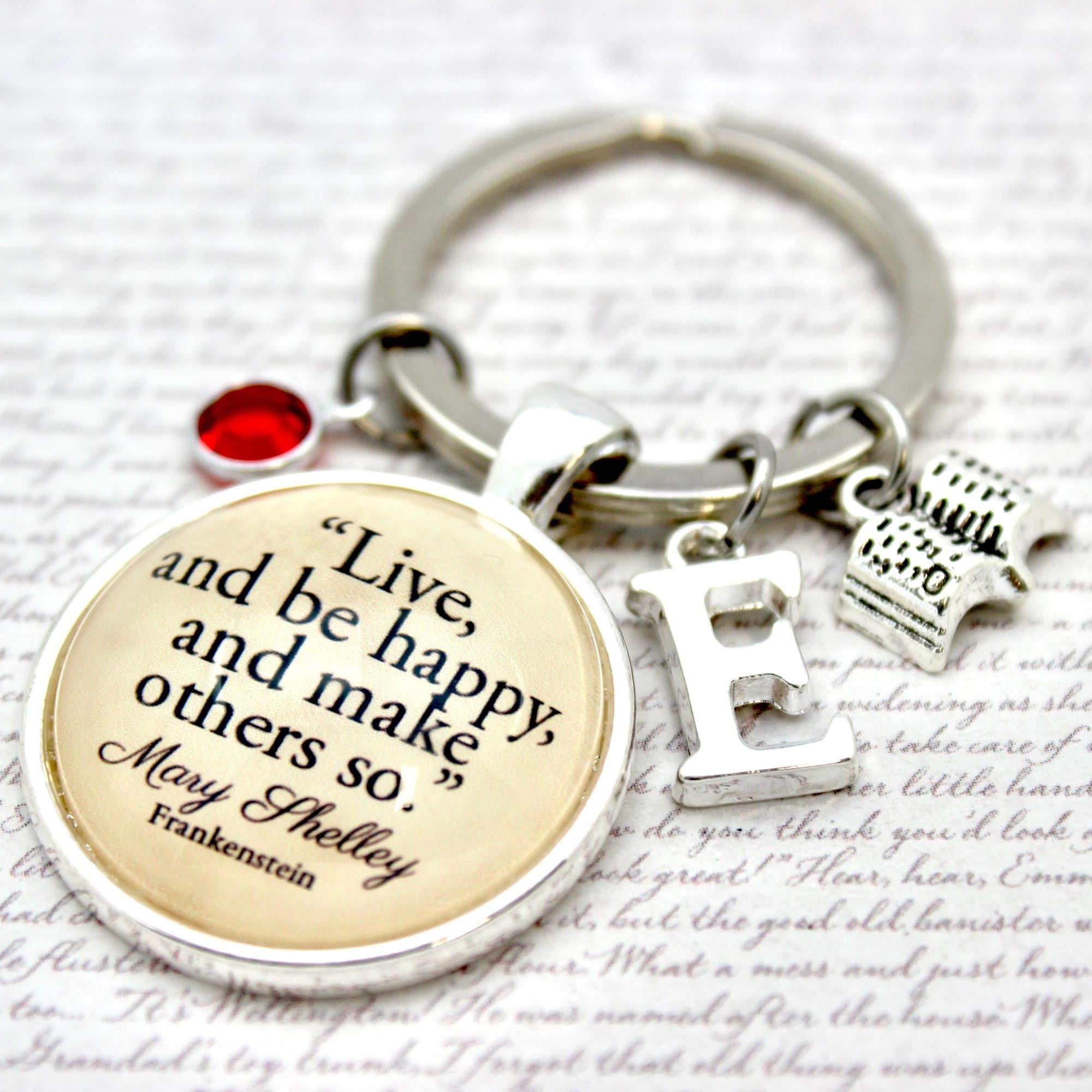 Keychain with motivational quote and small charms on a light background