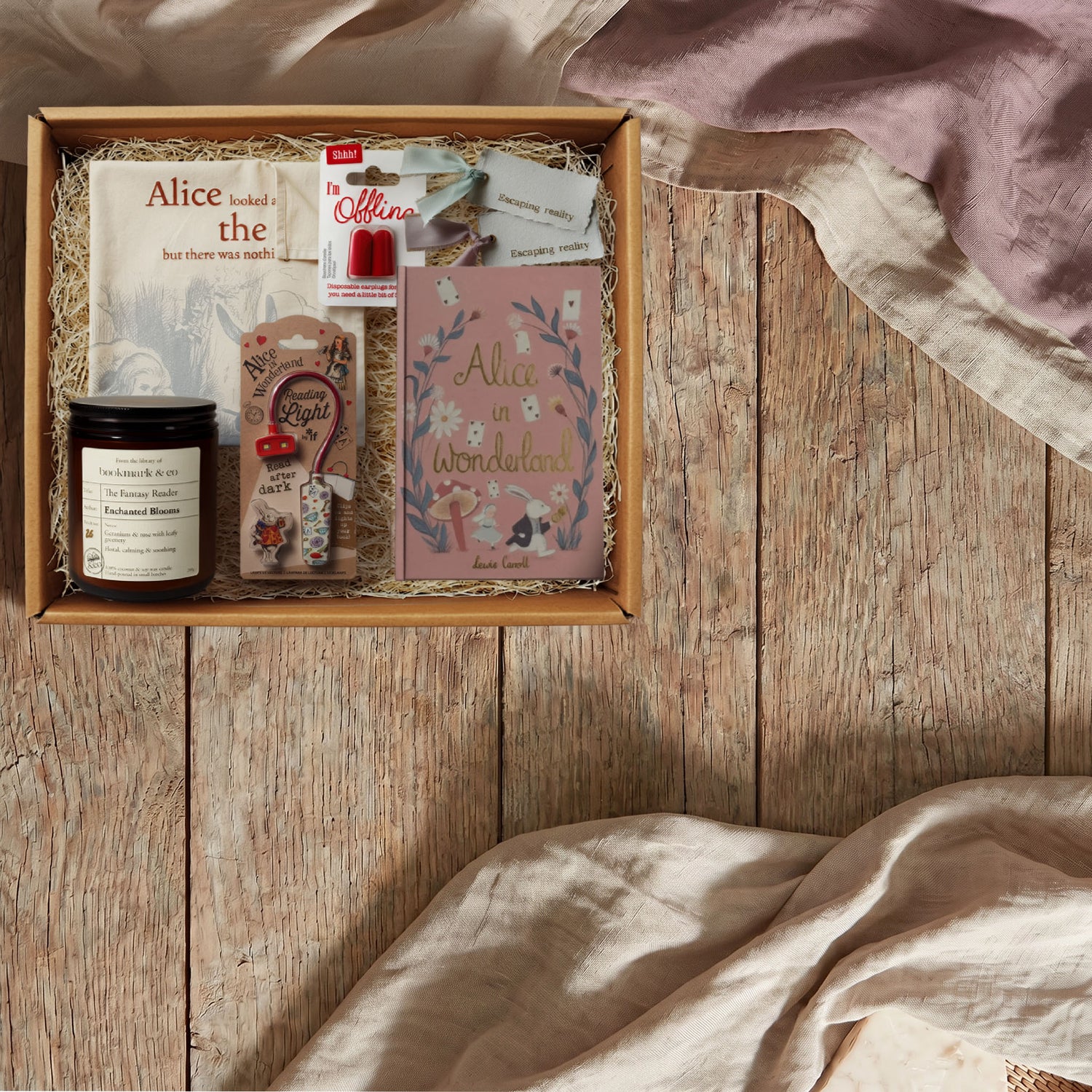 Gift box with stationery items on a wooden surface