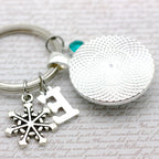 Silver keychain with snowflake charm and round pendant 