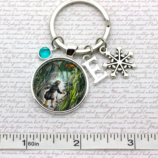 Keychain with a circular pendant featuring an illustration of Lucy and Aslan