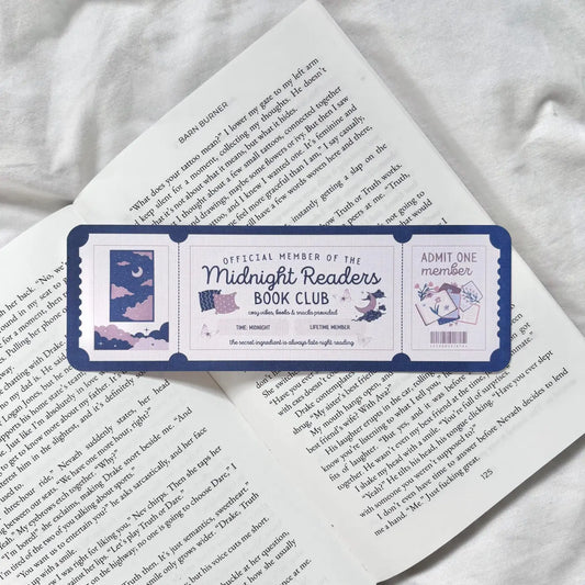 Book with a Midnight Readers Book Club bookmark on a white surface