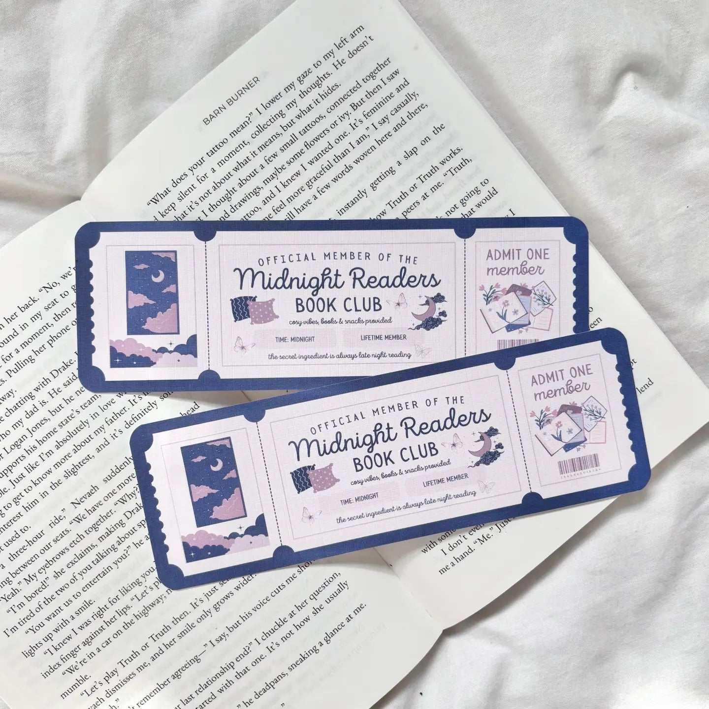 Two 'Midnight Readers Book Club' membership cards on a book page.