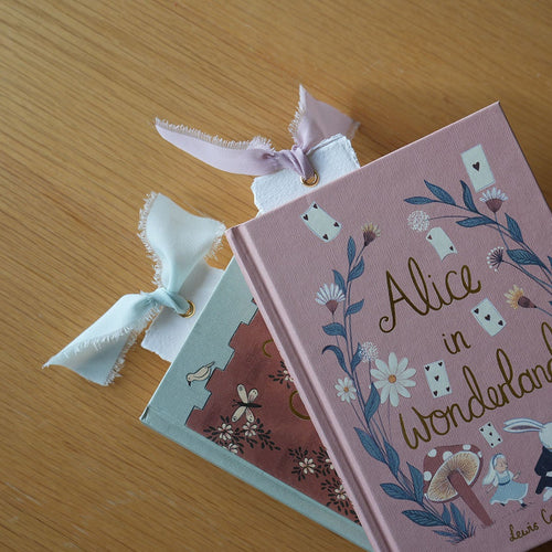 Paper bookmarks with ribbon in books | Bookmark & Co