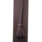 Tan brown bookmark with a tassel on a white background