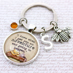 Keychain with inspirational quote and charms on a textured background