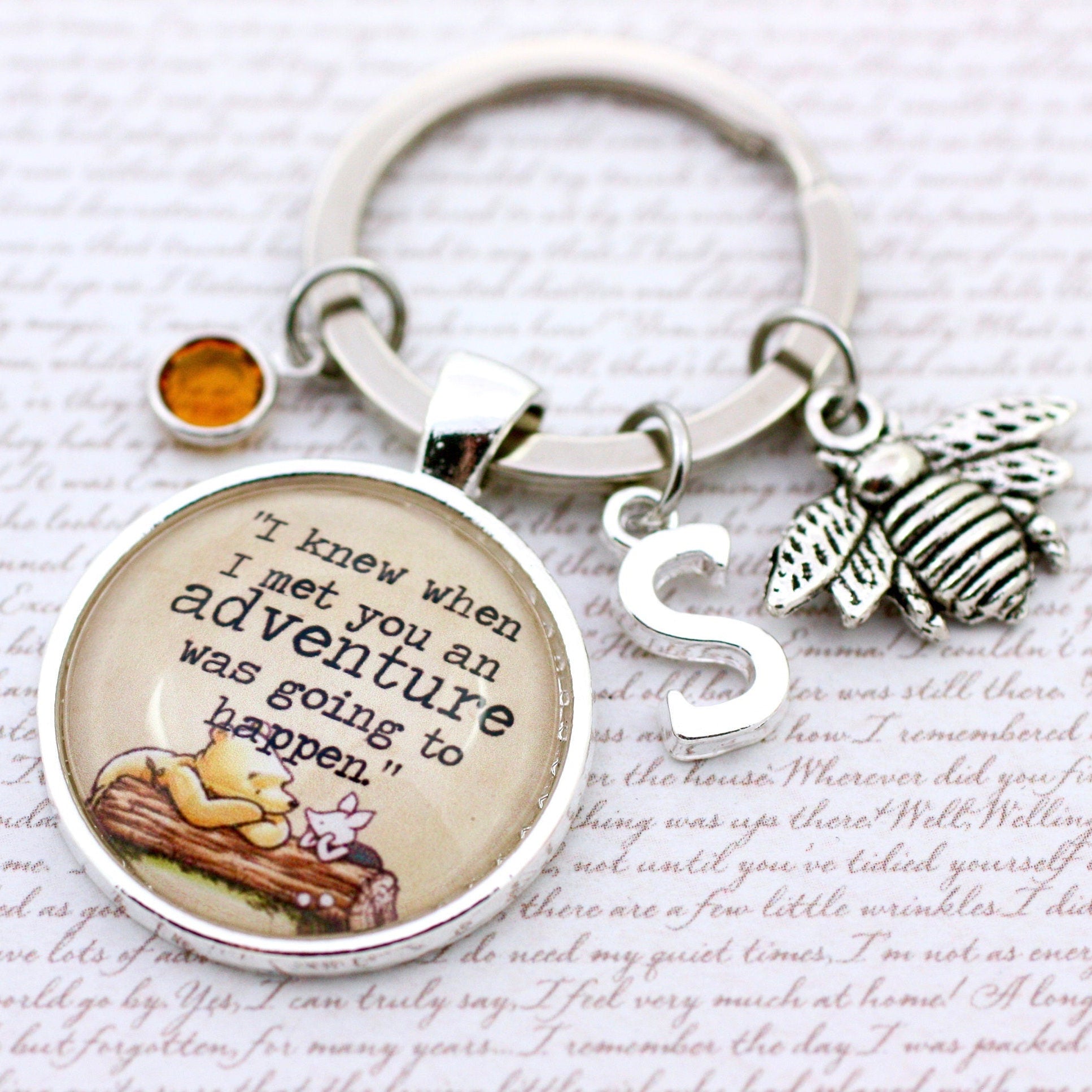 Keychain with inspirational quote and charms on a textured background