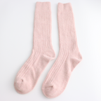 Pair of pink winter socks on a light grey background