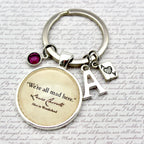 Keychain with circular charm featuring text and letter 'A' on a textured background