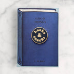 Blue book with 'books & snacks' emblem on a marble background