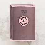 Book with a pink label on a marble surface