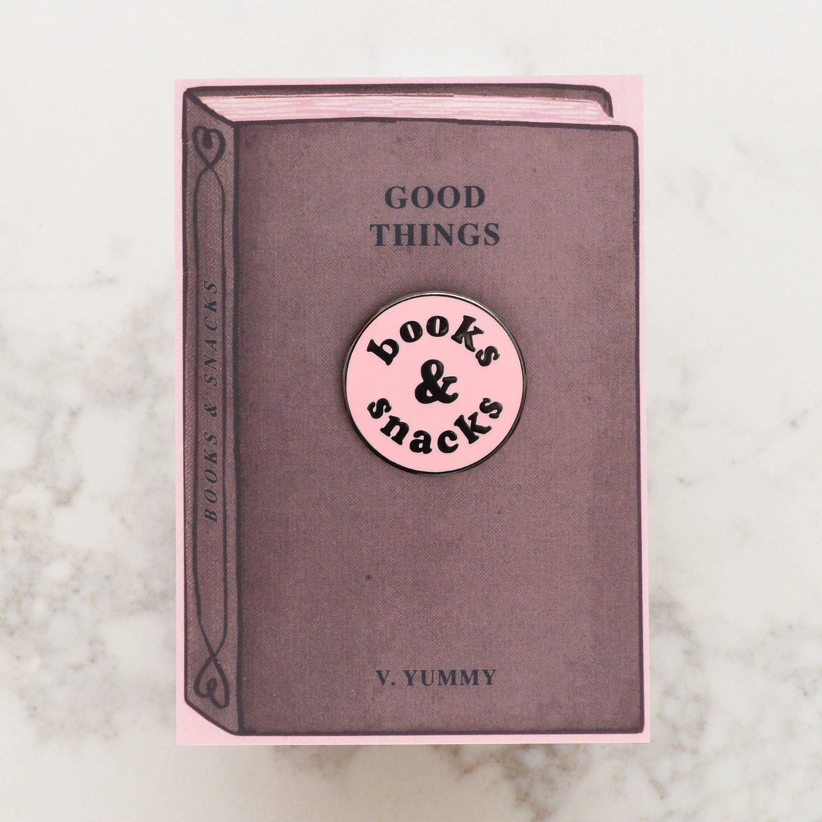 Book with a pink label on a marble surface