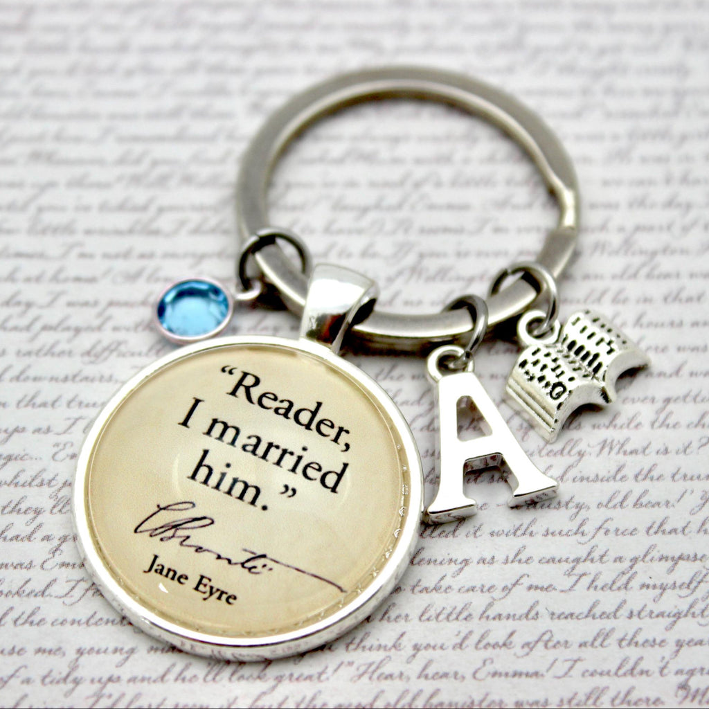 Keychain with 'Reader, I married him' quote from Jane Eyre on a textured background
