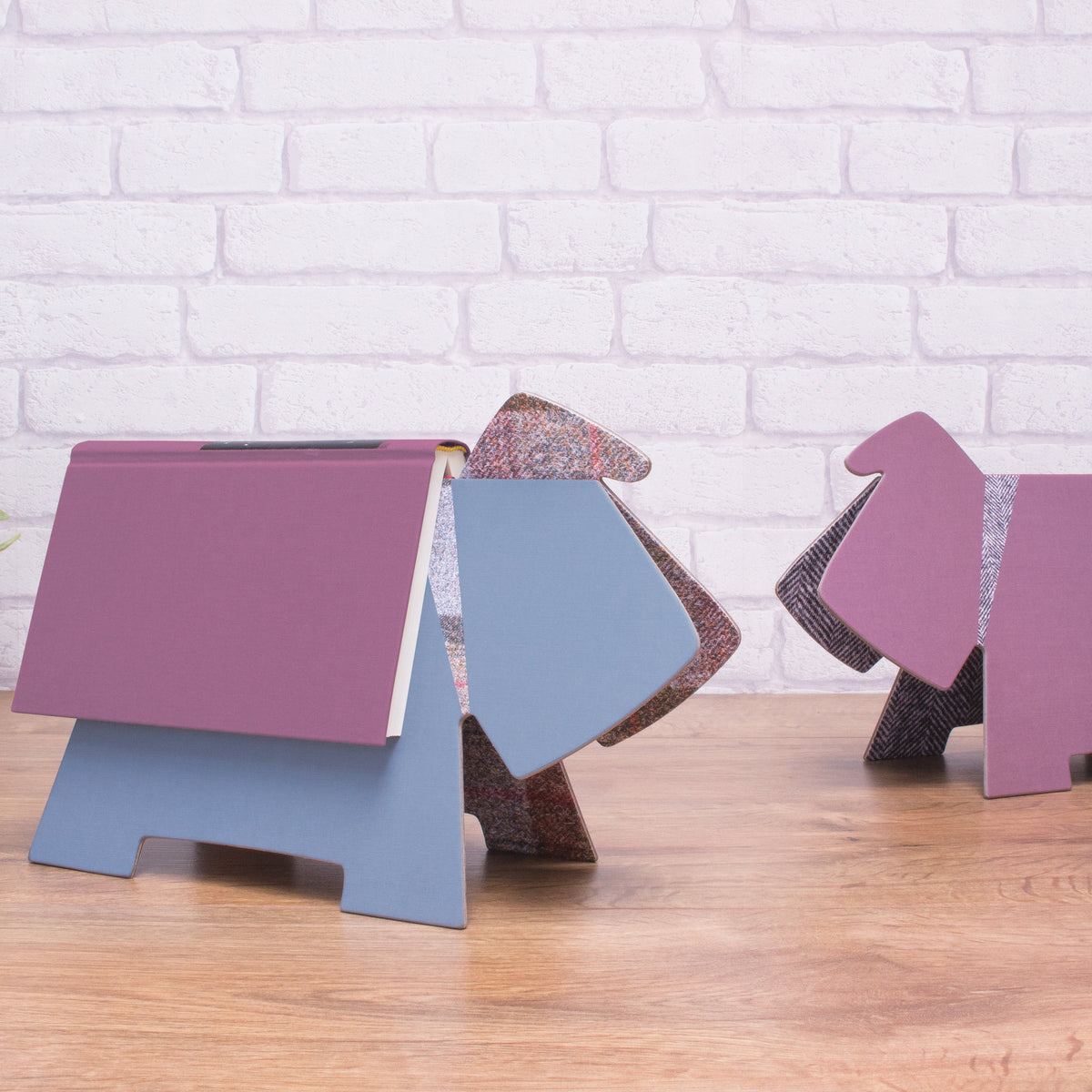 Color swatch samples on a wooden surface with a white brick wall background