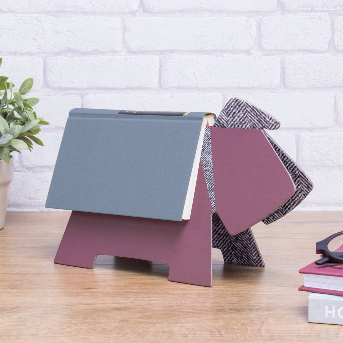 dog shaped book rest with blue book on it