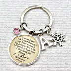 Keychain with text and charms on a textured surface