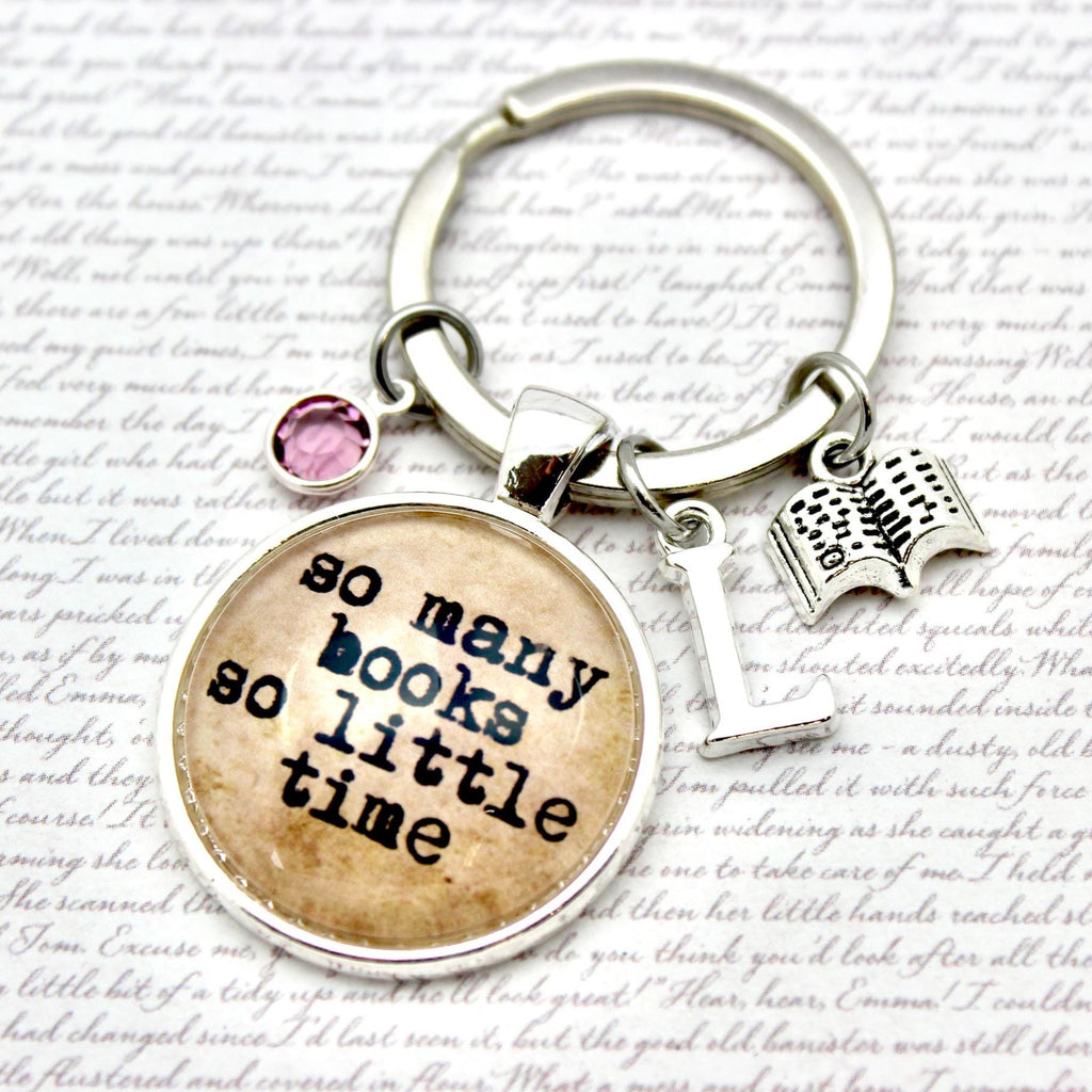 Keychain with 'so many books so little time' charm on a textured background