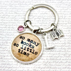 Keychain with 'so many books so little time' charm on a textured background