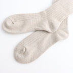 Pair of Oatmeal coloured socks on a white background