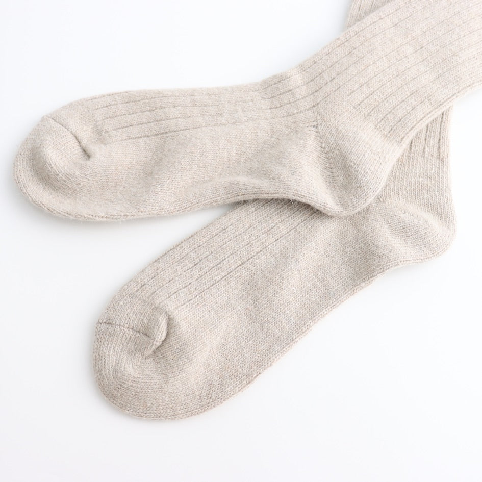 Pair of Oatmeal coloured socks on a white background