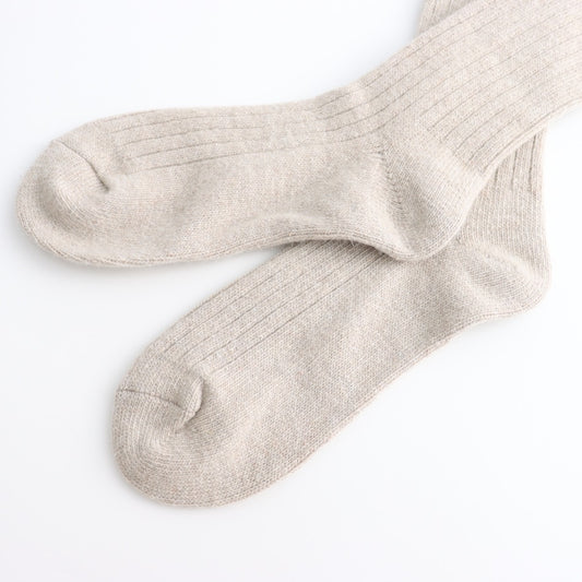 Pair of Oatmeal coloured socks on a white background
