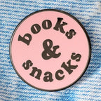 Circular pink badge with 'books & snacks' text on a blue textured background