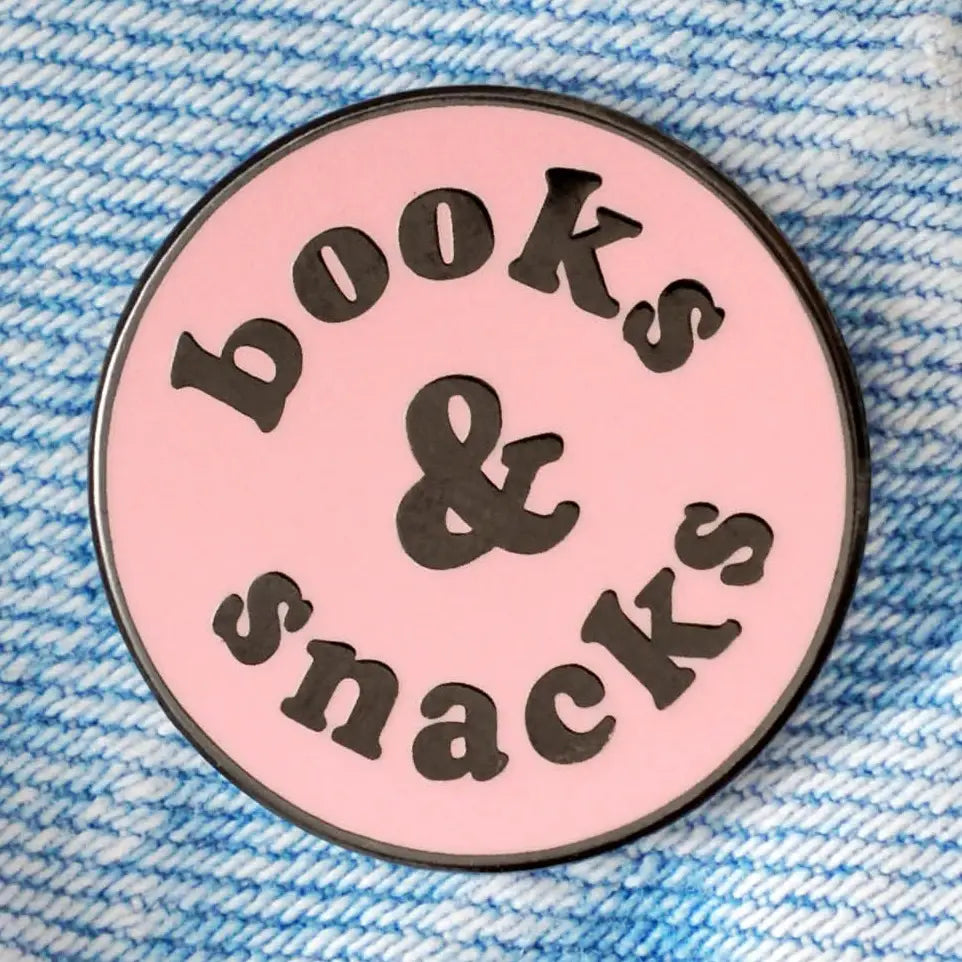Circular pink badge with 'books & snacks' text on a blue textured background