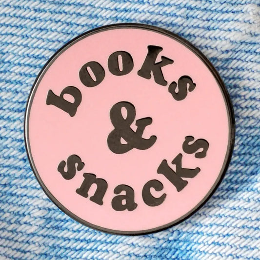 Circular pink badge with 'books & snacks' text on a blue textured background