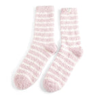 Pair of pink and white striped socks on a white background