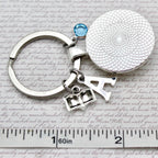 Keychain with round silver charm and  pendant 