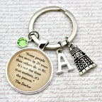 Keychain with motivational quote and decorative elements on a textured background