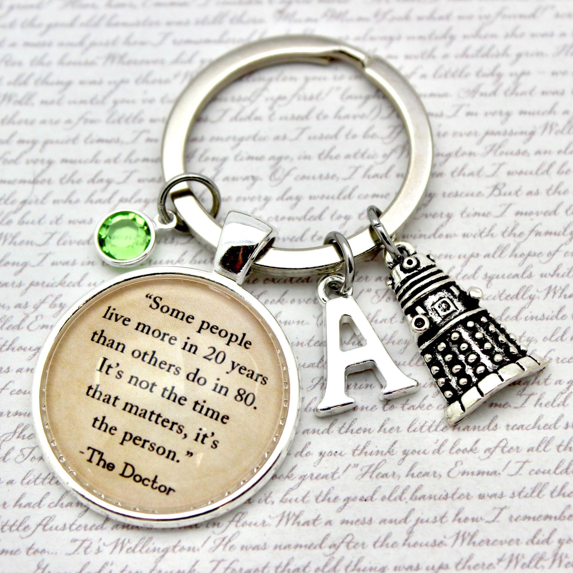 Keychain with motivational quote and decorative elements on a textured background