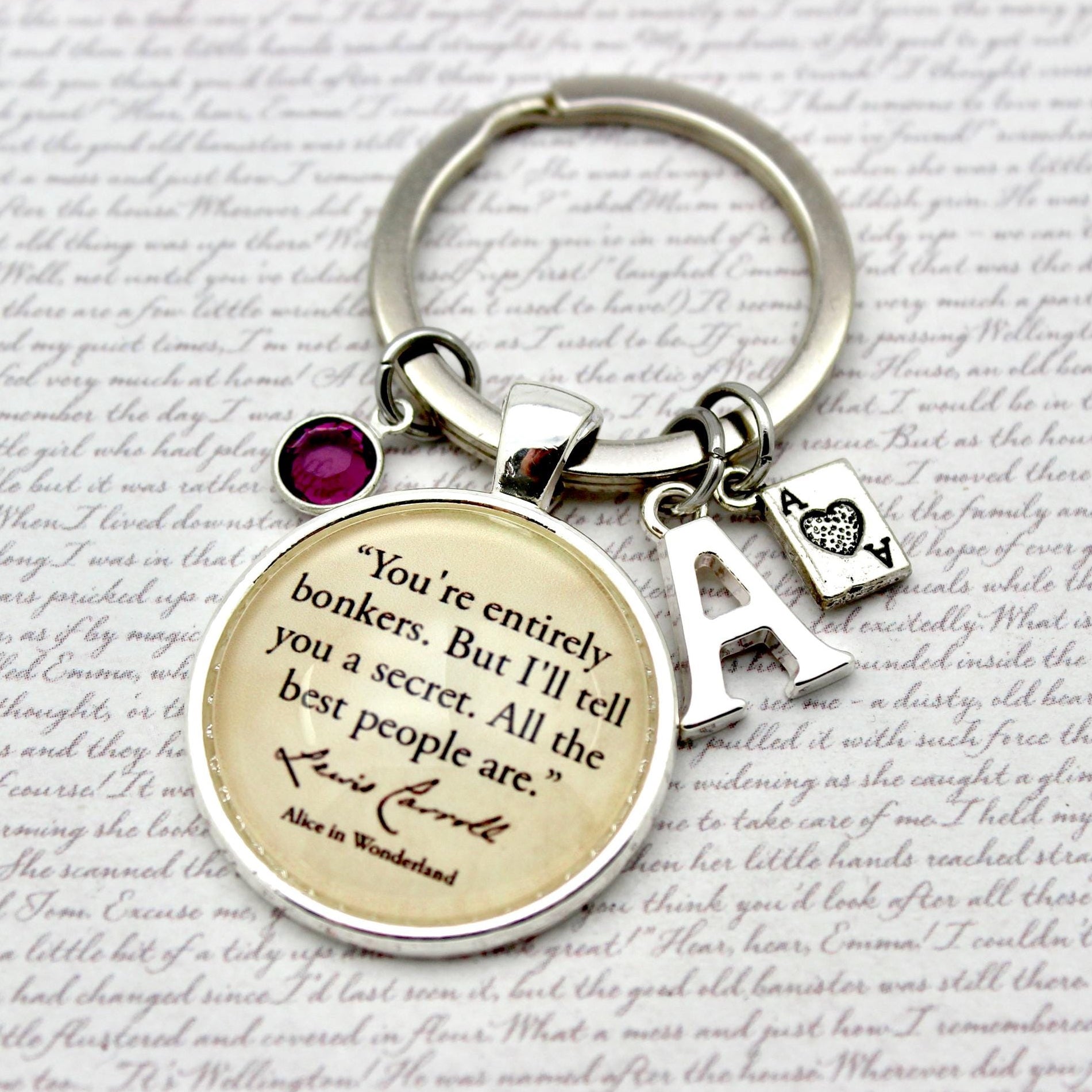 Keychain with circular charm featuring text and initials on a textured background